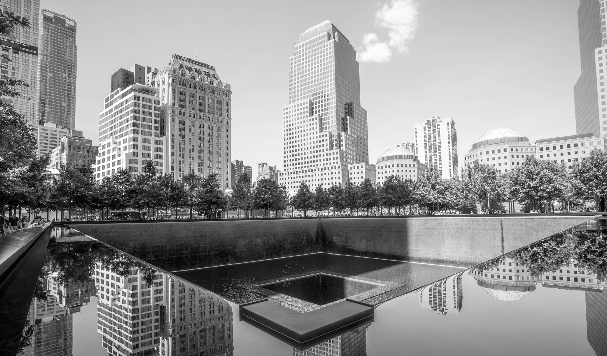 9/11 Memorial reflecting pool with Manhattan skyline, black and white